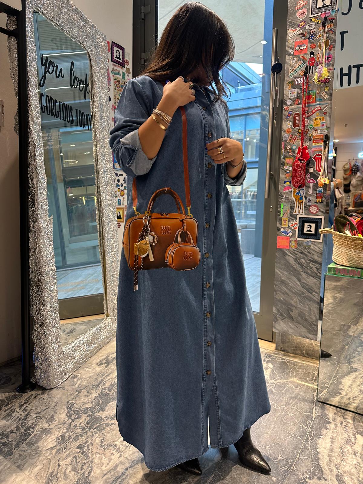 Brown bag on long denim dress