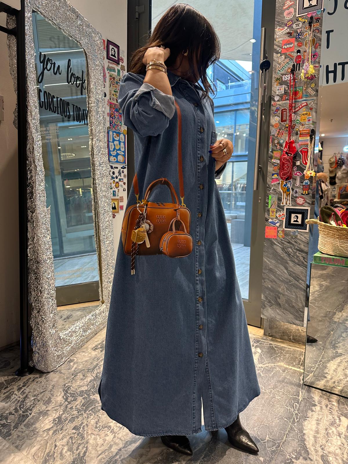 Brown bag on long denim dress